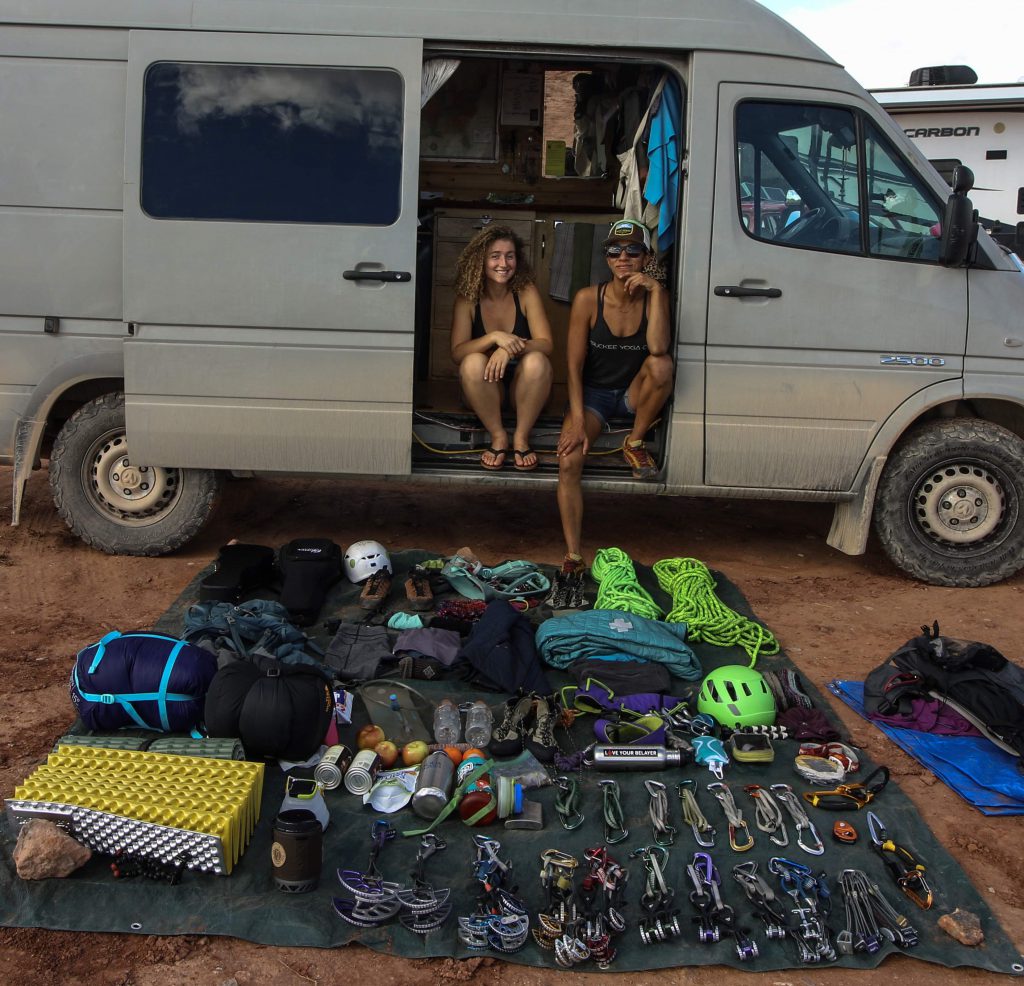Kaya Lindsay and Dani Reyes-Acosta sitting in front of their gear for an overnight climb
