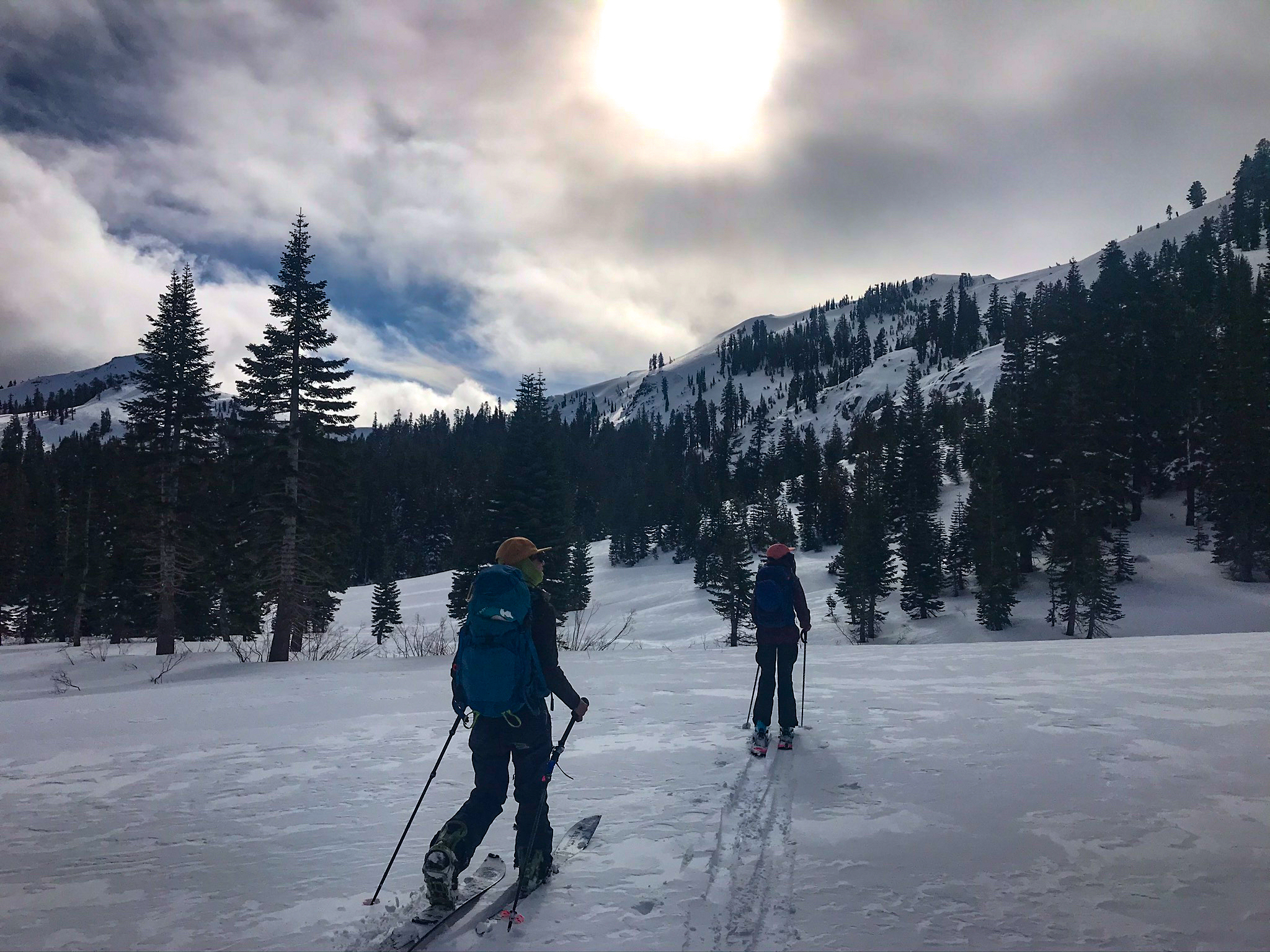 Two-women-ski-uphill-California-backcountry
