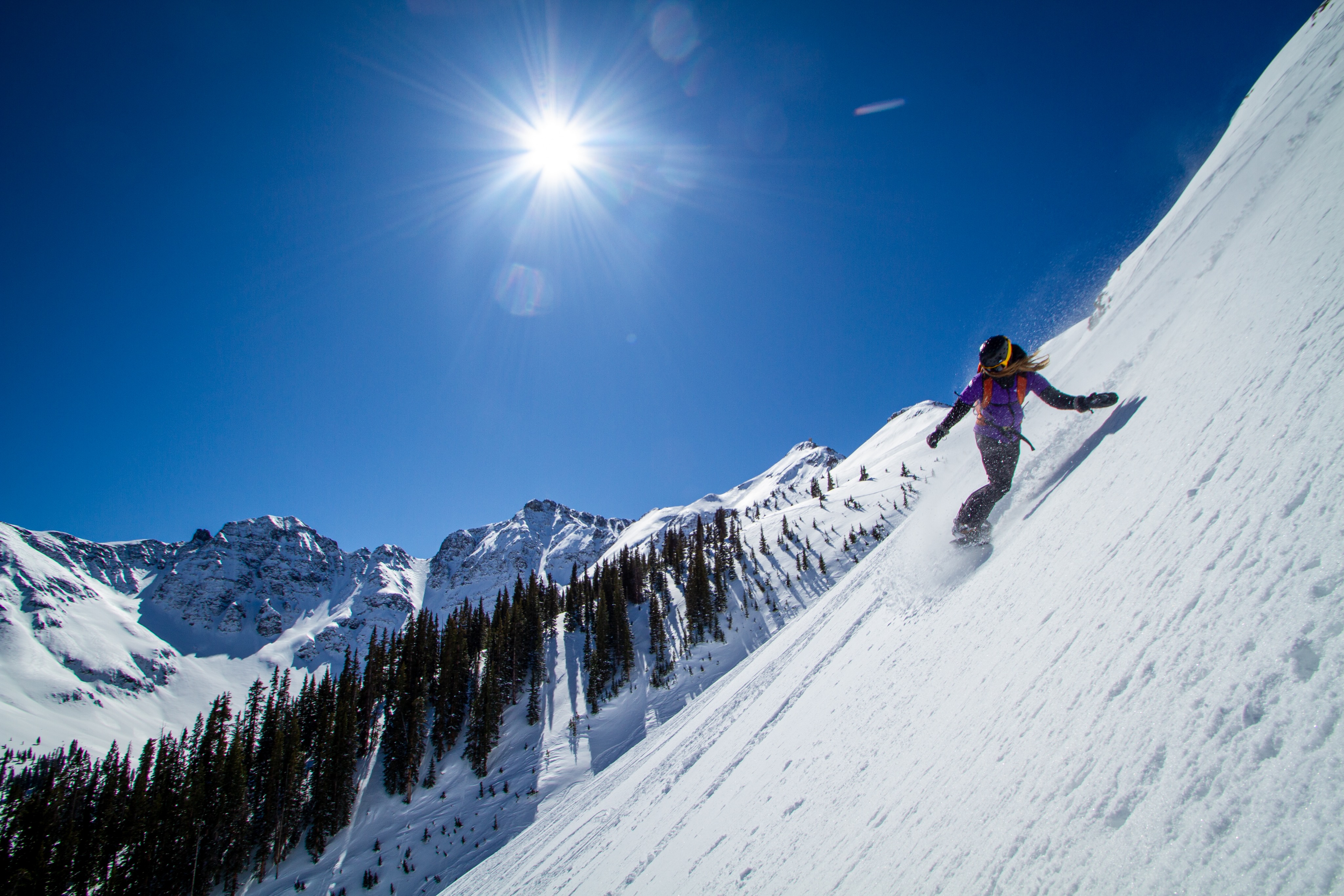 Silverton-Mountain-co-founder-Jen-Brill-snowboards-down-a-steep-face-at-her-home mountain-in-Colorado.
