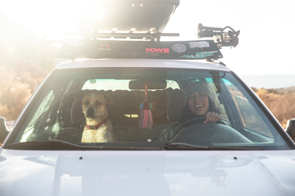 Mexican-Filipina-woman-prepared-to-drive-to-an-adventure-with-dog-friend