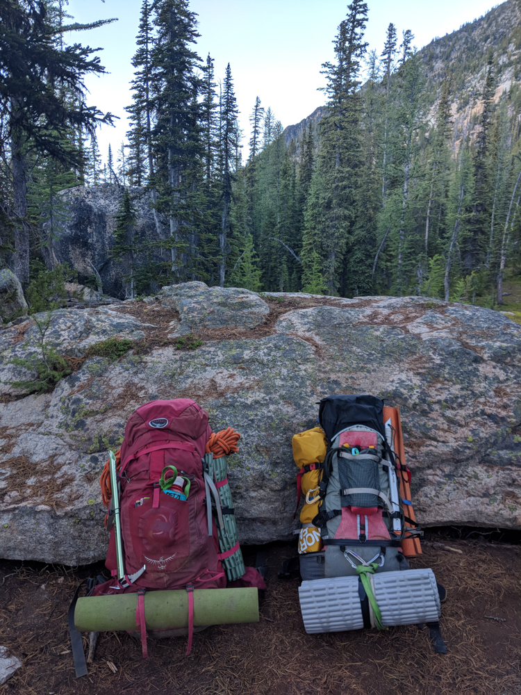 Two-climbers-backpacks-ready-for-descent-include-trash-leave-no-trace-leave-only-footprints