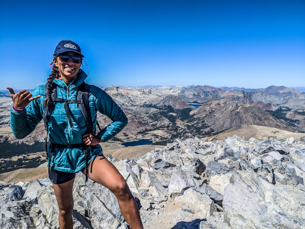 Mexican-Filipina trail runner trail running in alpine gains Mt. Dana summit, Yosemite National Park. Photo Dani Reyes-Acosta