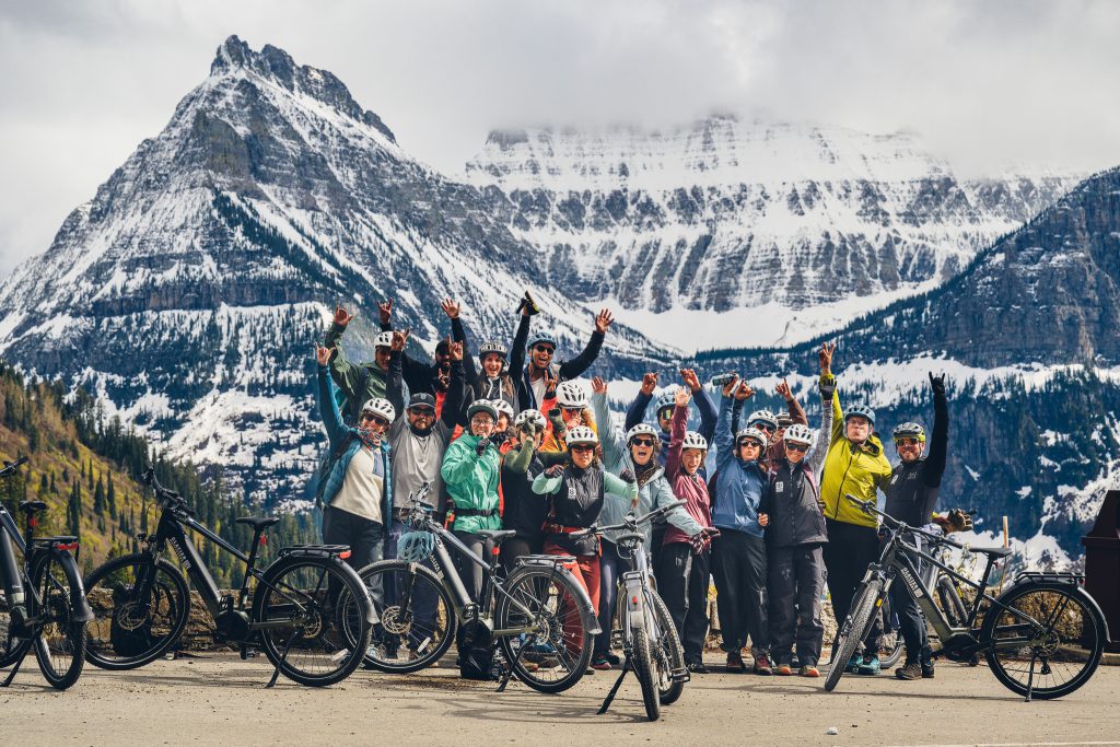 Group of mountain bikers in front of mountains